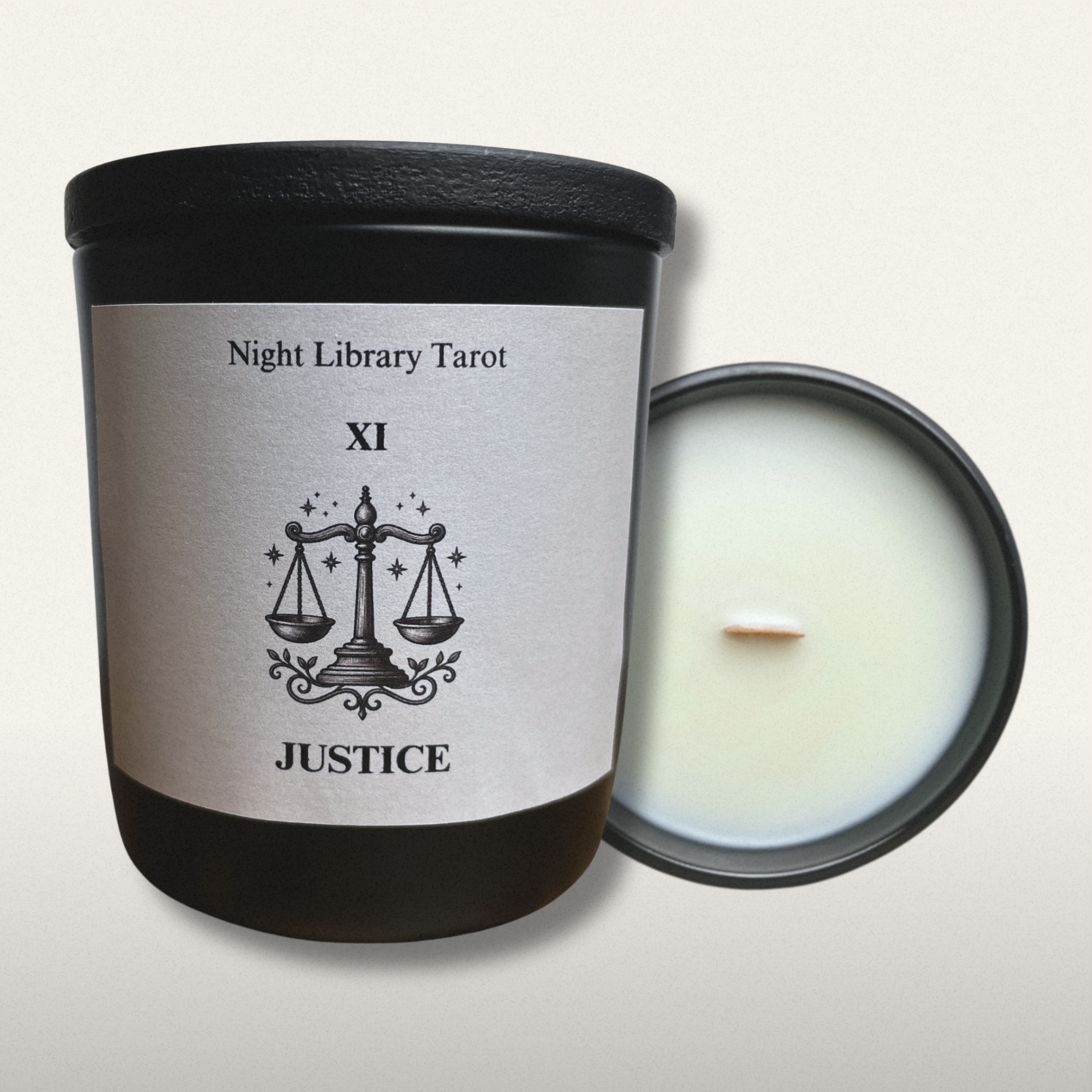 Candle with 'Night Library Tarot Justice' label on a light gray background