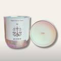 Candle in a glass jar with a label featuring 'Night Library Tarot' and 'XI Justice' on a light background.