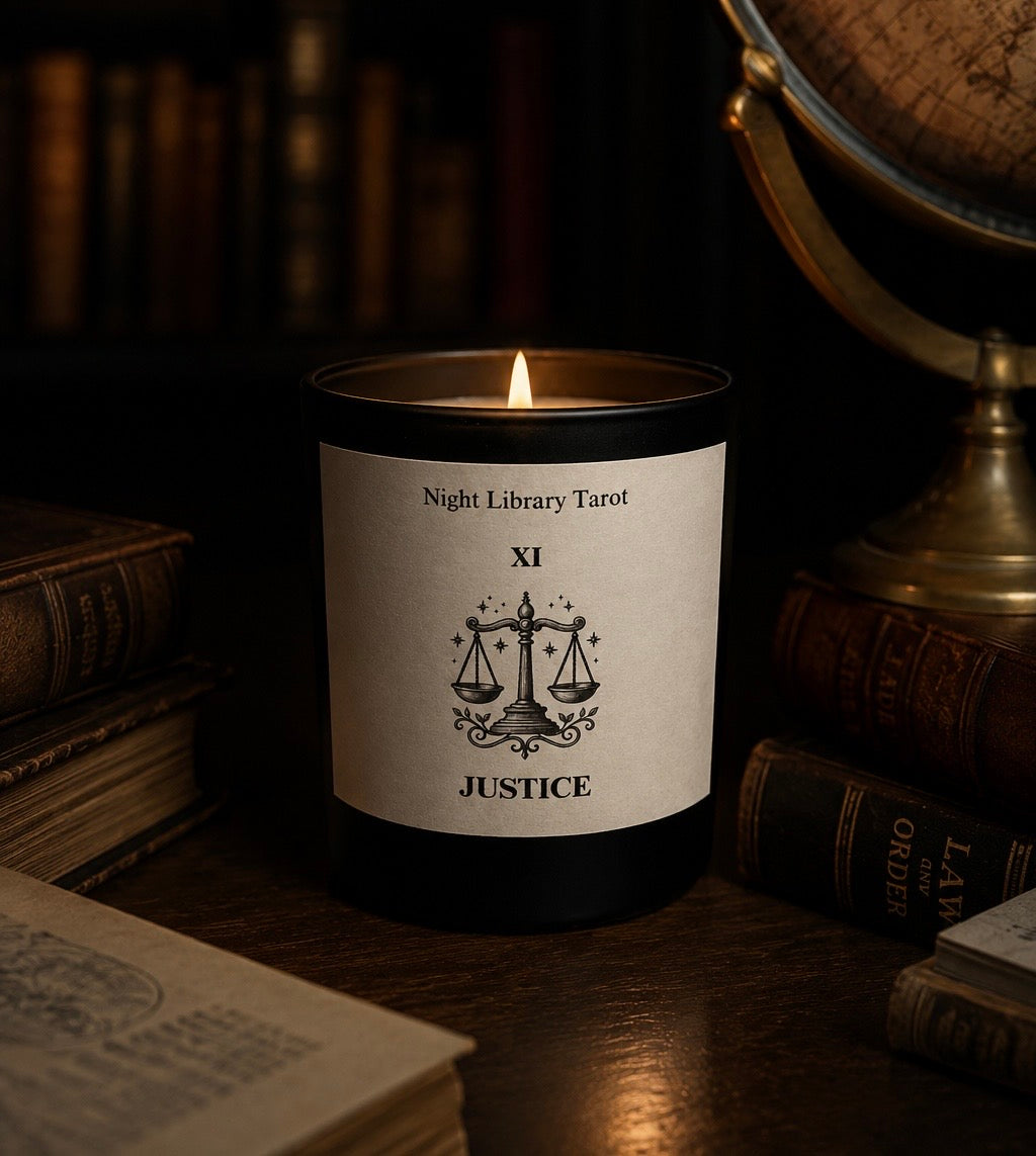 Candle labeled 'Justice' from 'Night Library Tarot' with books and a globe in the background