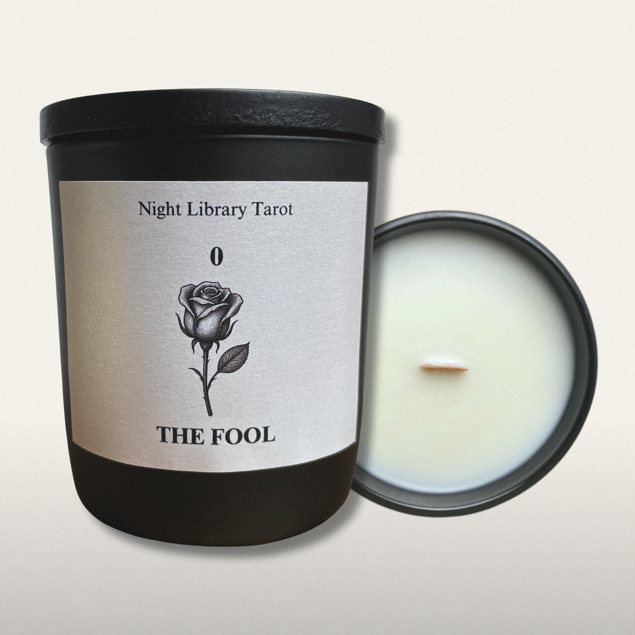 Candle with a label featuring a rose and text on a white background
