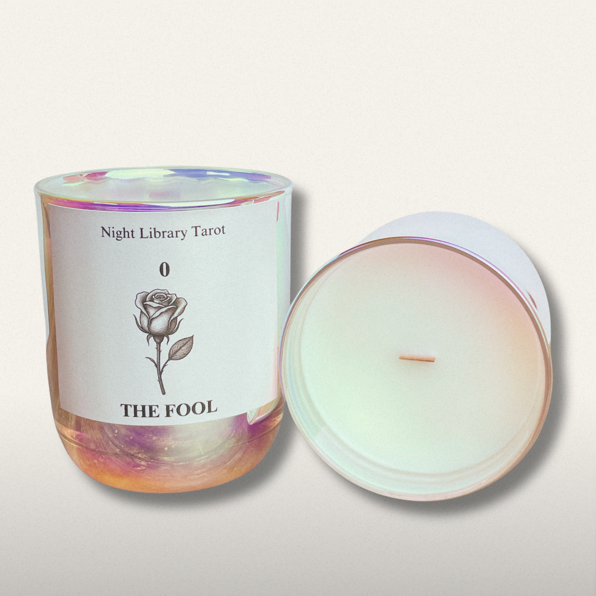 Candle with a label featuring 'The Fool' from Night Library Tarot on a light background