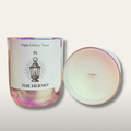 Candle with a label titled 'The Hermit' from Night Library Tarot on a light background