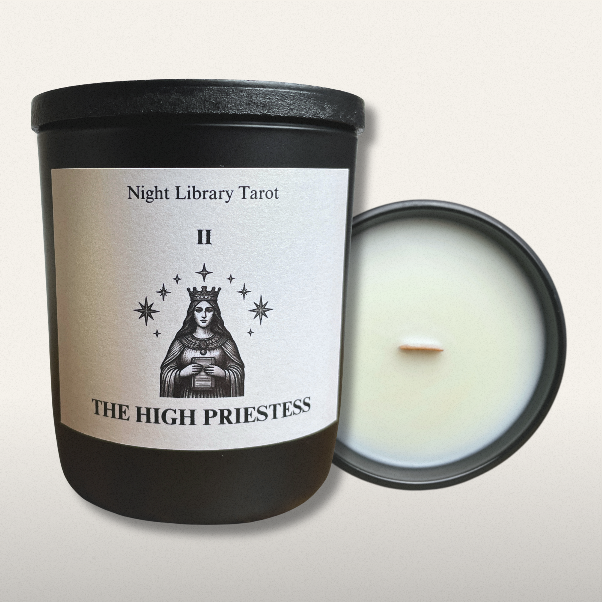 Candle in a black container with 'The High Priestess' tarot card design on the label.