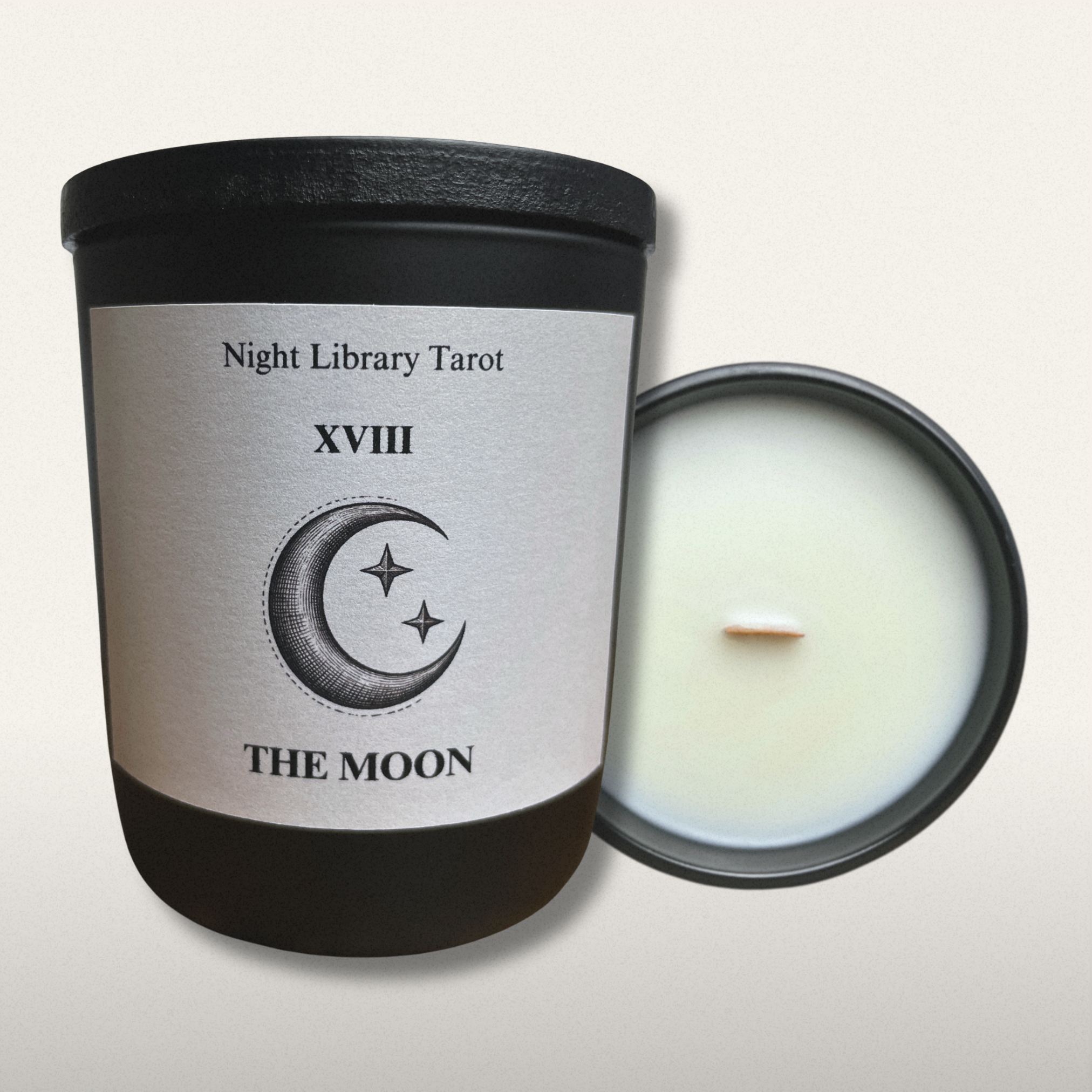 Candle with a label featuring a moon and star design, titled 'The Moon' from 'Night Library Tarot'.