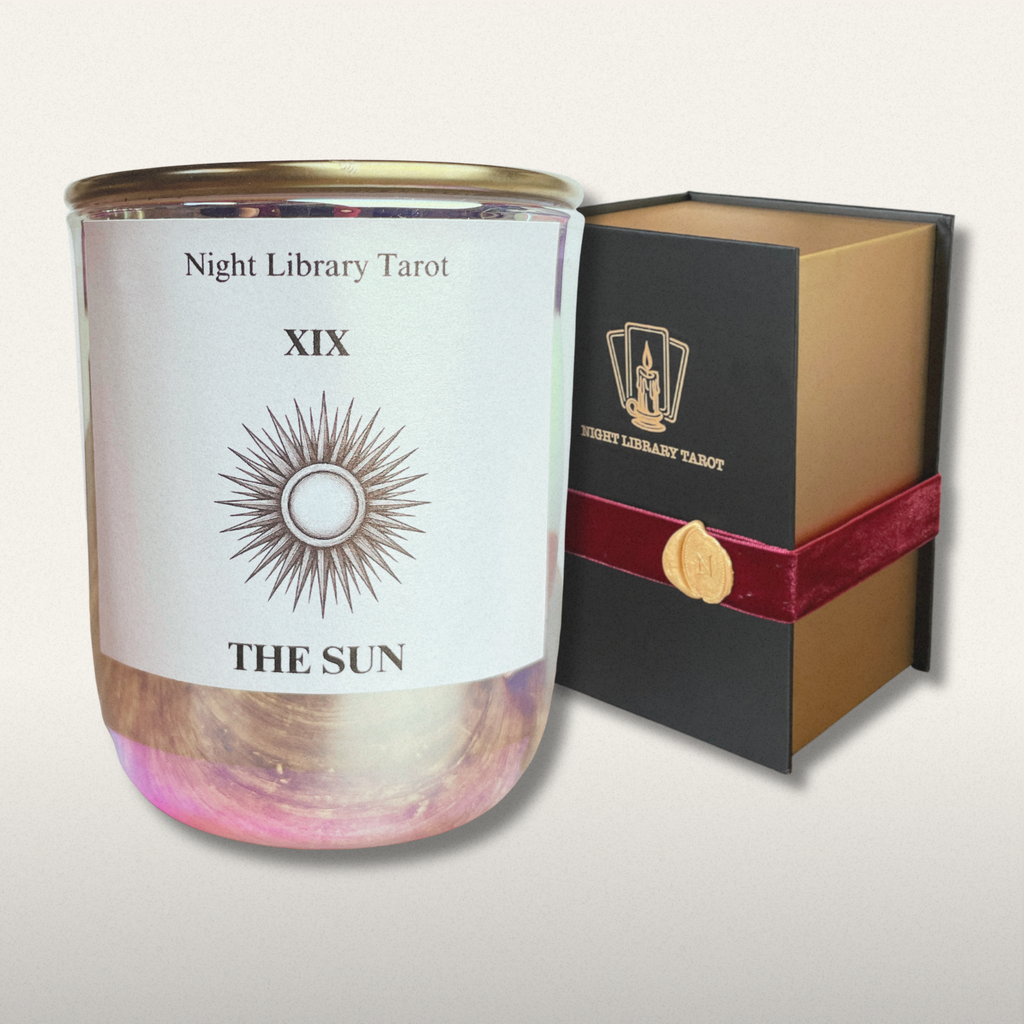 Candle with 'Night Library Tarot' packaging on a light gray background